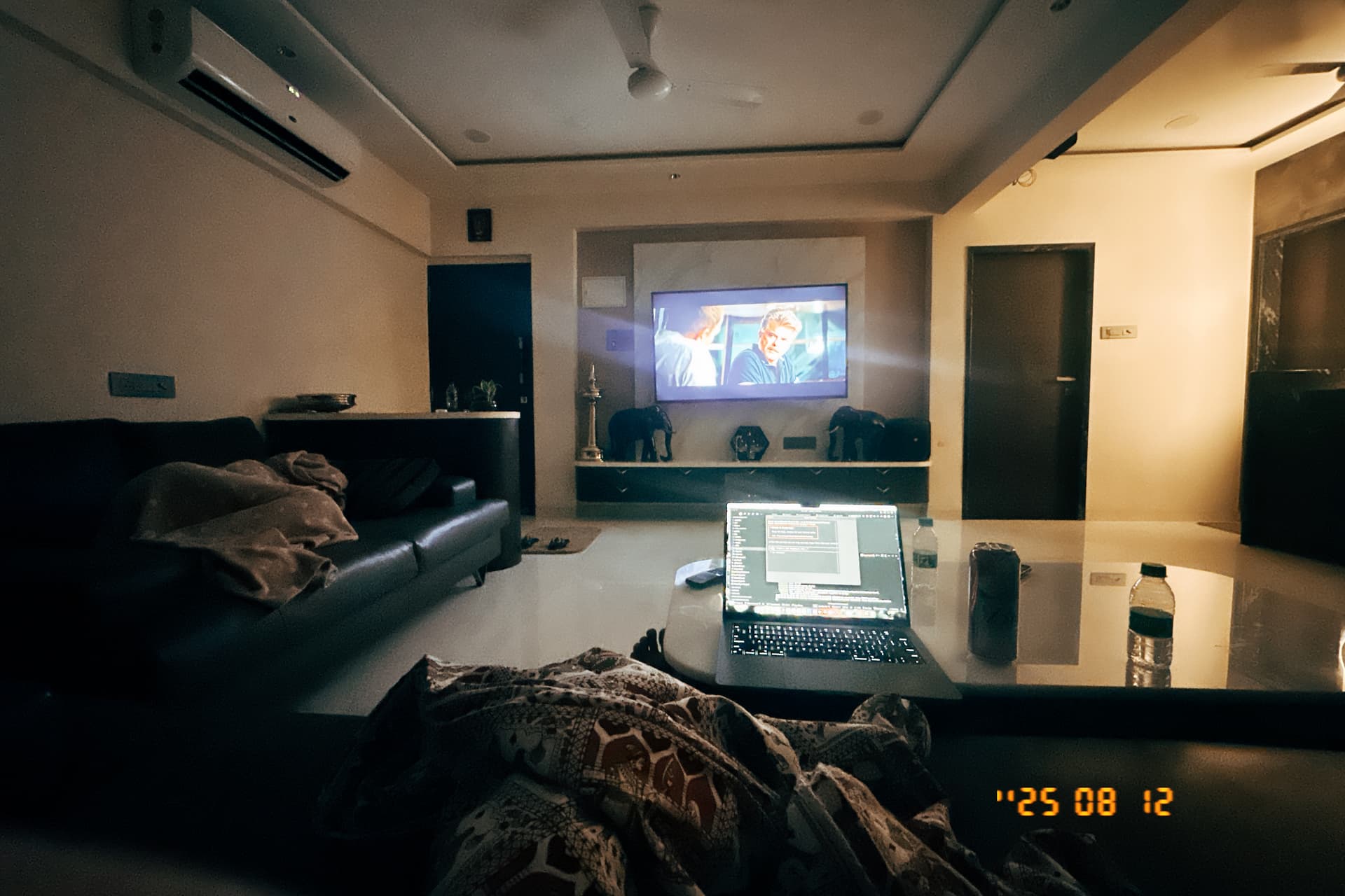 Late-night coding setup with a laptop and projector